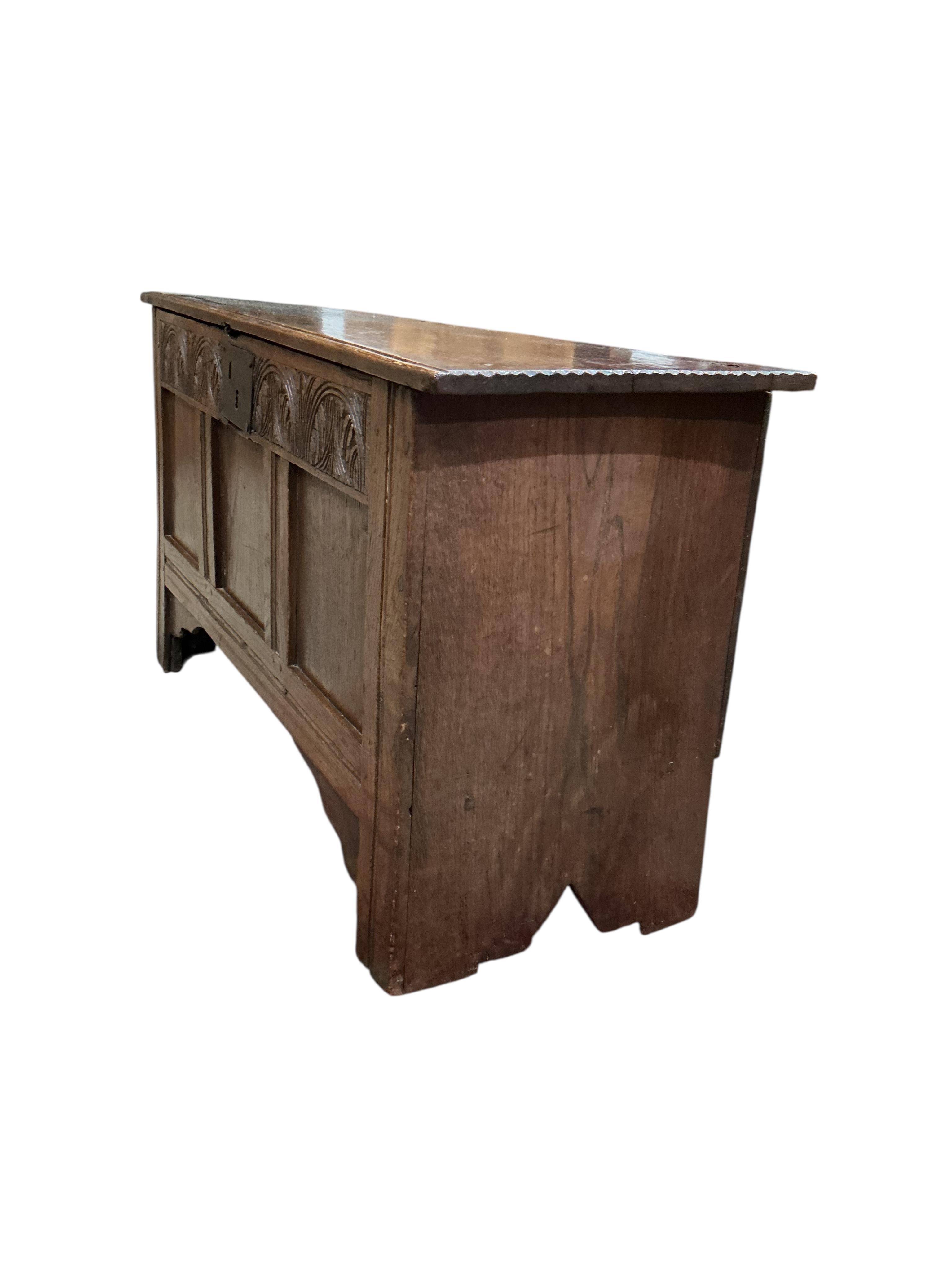 A small 17th century oak chipped carved coffer, width 104cm, depth 36cm, height 57cm